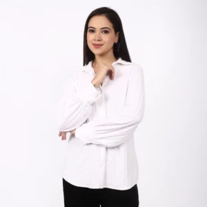 The cuff and sleeve detail of the ivory shirt.